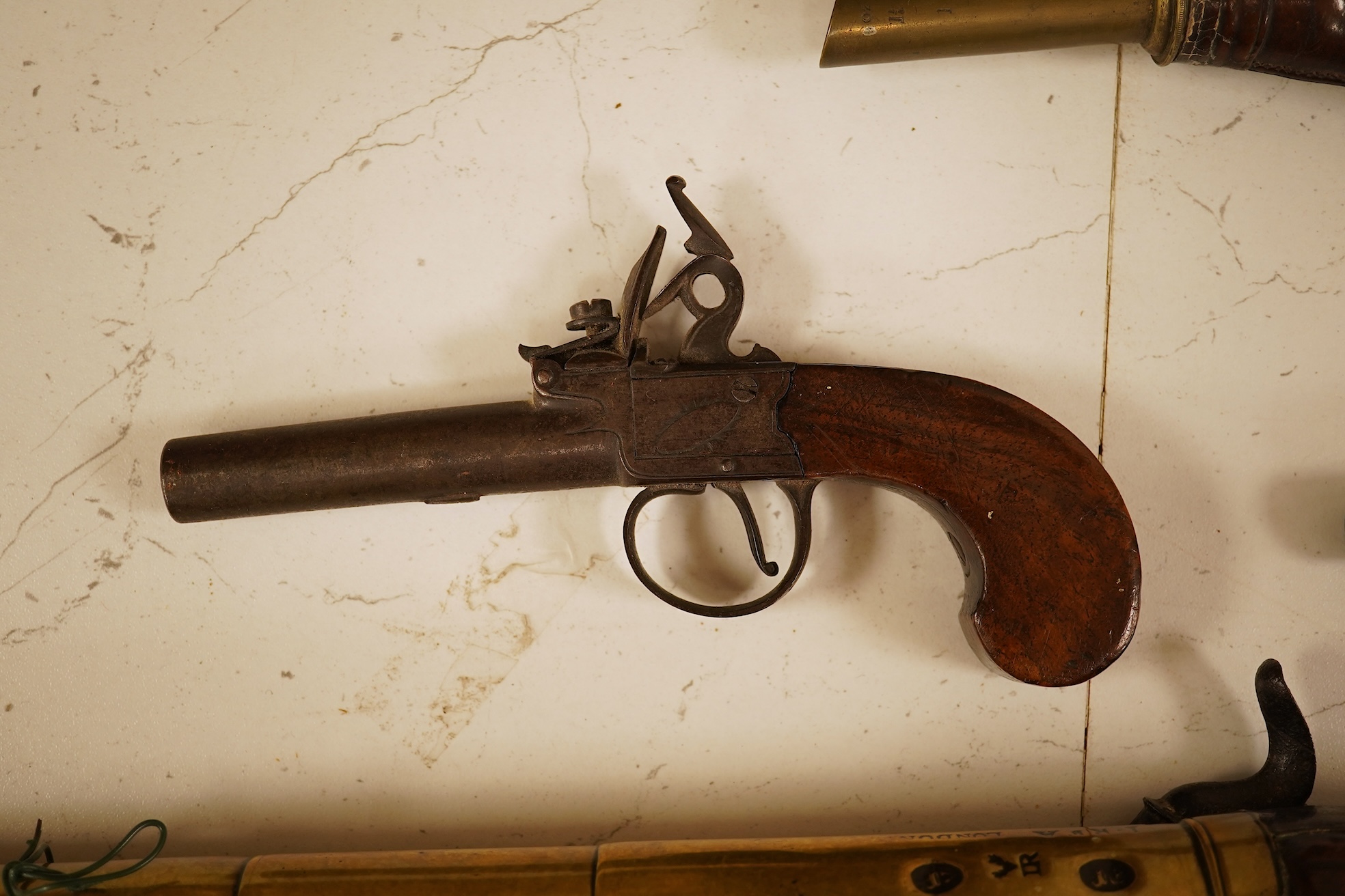 A pair of 19th century pocket pistols, shot flask and a brass musket, 81cm in length